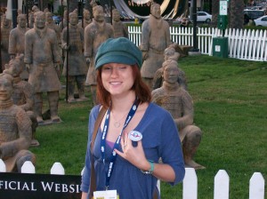 At Comic-Con International, Carly shows off her Rocket Llama sticker while standing in front of terracotta warriors from The Mummy: Tomb of the Dragon Emperor